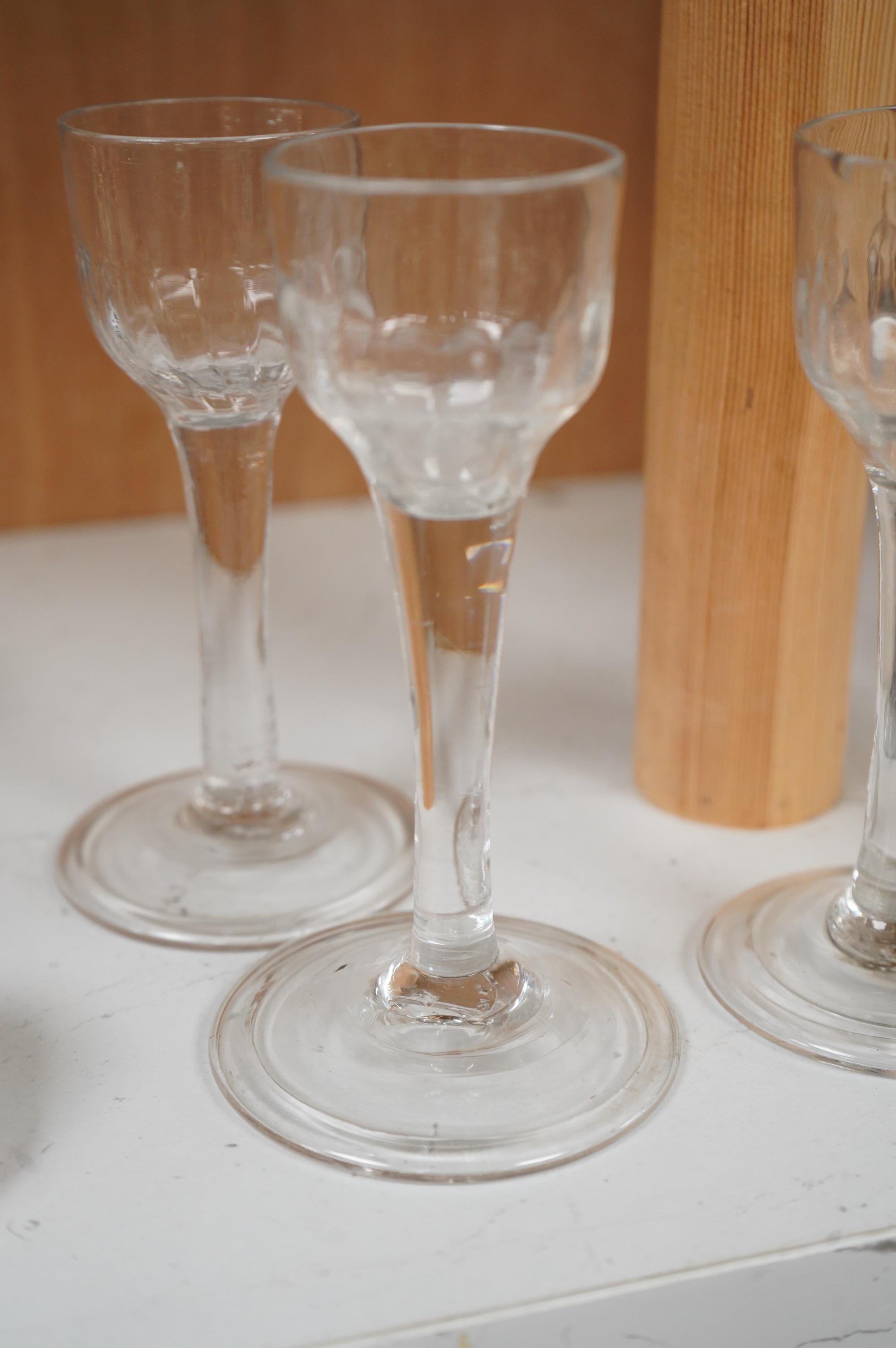 Five 18th century cordial glasses, in lead and soda glass, with fluted bowls, columnar stems, on domed and folded feet, 13.5cm high